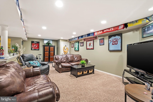 carpeted living area featuring decorative columns, baseboards, and recessed lighting