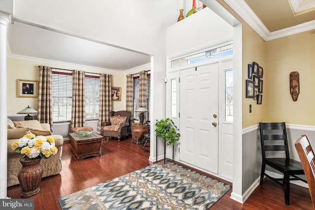 entryway with baseboards, ornamental molding, and wood finished floors