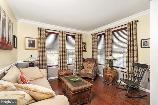 living area featuring a healthy amount of sunlight, crown molding, baseboards, and wood finished floors