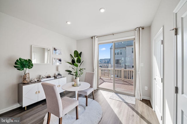 dining room with recessed lighting, baseboards, and light wood-style floors