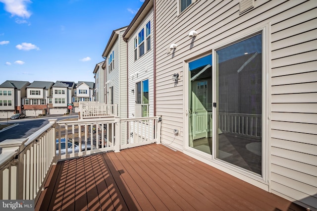 wooden deck with a residential view