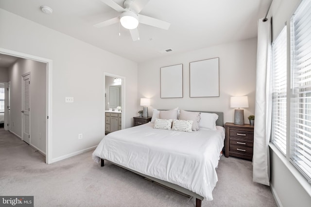 bedroom featuring visible vents, multiple windows, and light colored carpet