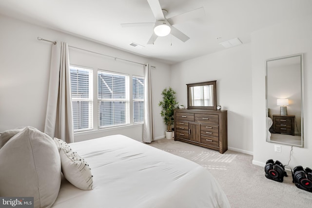 bedroom with visible vents, light colored carpet, a ceiling fan, and baseboards