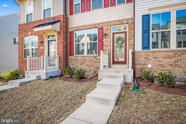 entrance to property with brick siding