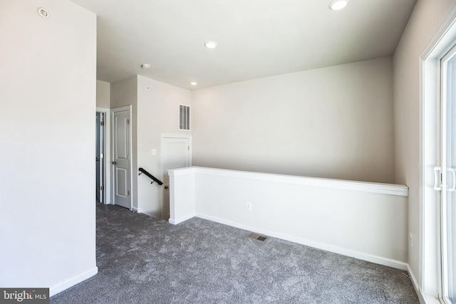 unfurnished room featuring recessed lighting, carpet flooring, visible vents, and baseboards