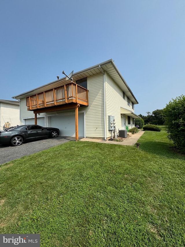 view of property exterior featuring central AC unit and a lawn