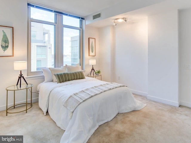 bedroom with carpet flooring, visible vents, and baseboards