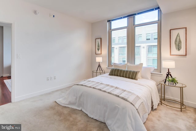 bedroom featuring baseboards and carpet flooring