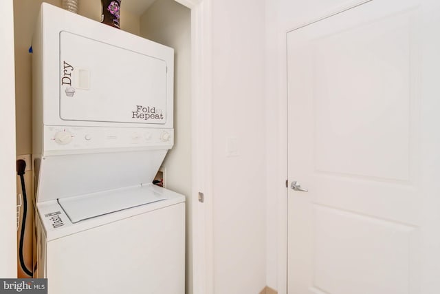 laundry room featuring stacked washer and dryer and laundry area