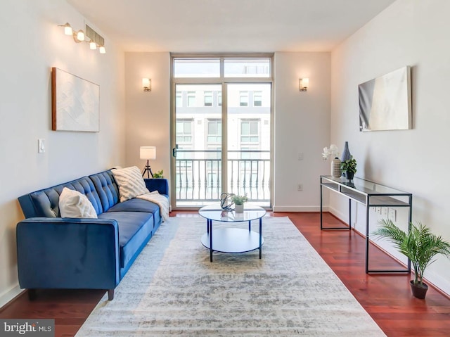 living room featuring baseboards, dark wood-style flooring, plenty of natural light, and floor to ceiling windows