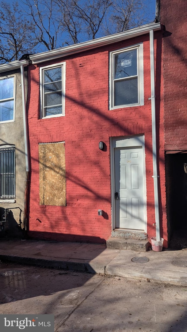 exterior space with brick siding