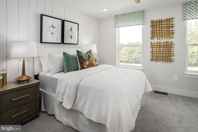 bedroom with multiple windows, carpet, and visible vents