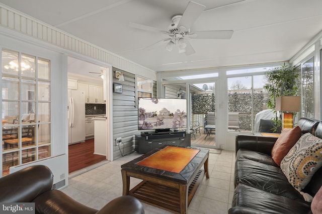 sunroom featuring ceiling fan