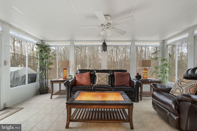 sunroom / solarium featuring a ceiling fan