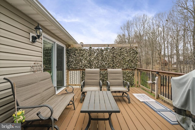 wooden terrace with a grill