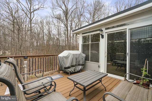 wooden terrace featuring a grill