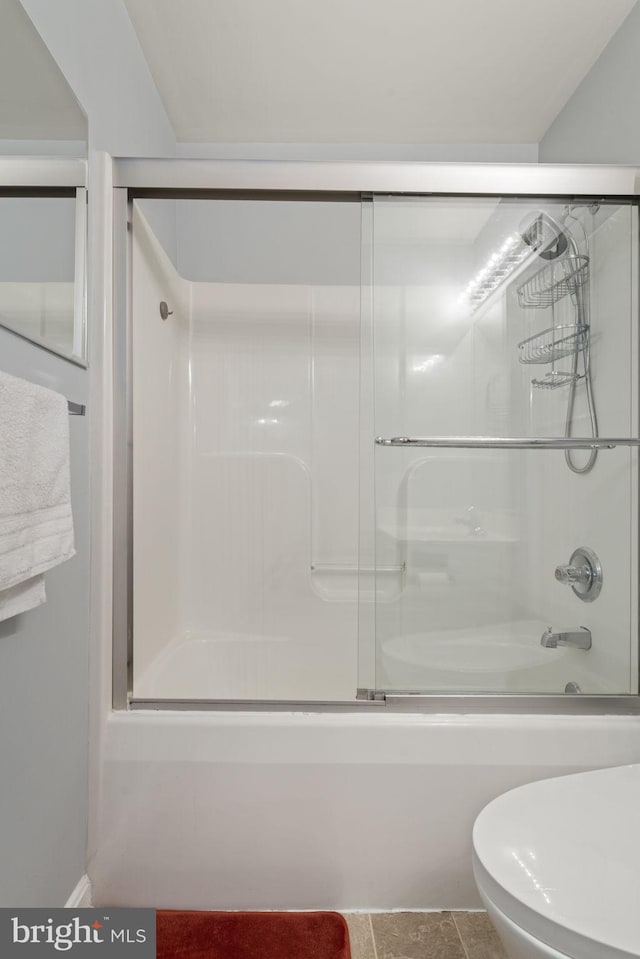 bathroom featuring shower / bath combination with glass door