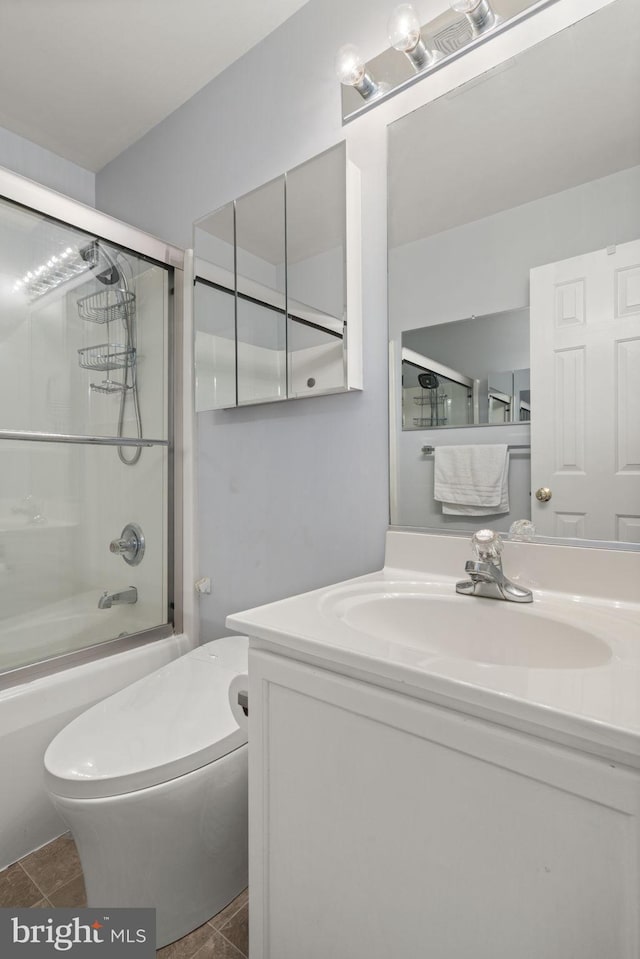 bathroom with enclosed tub / shower combo, toilet, and vanity