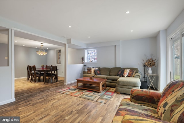 living room featuring recessed lighting, baseboards, and wood finished floors