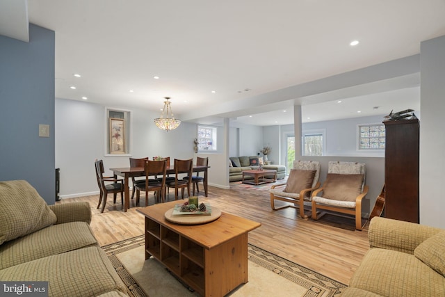 living area with recessed lighting, baseboards, and light wood-style flooring