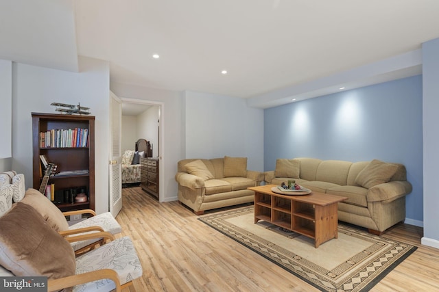 living area with recessed lighting, baseboards, and light wood-style floors