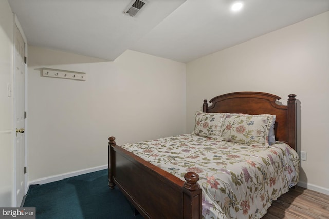 bedroom with baseboards and visible vents