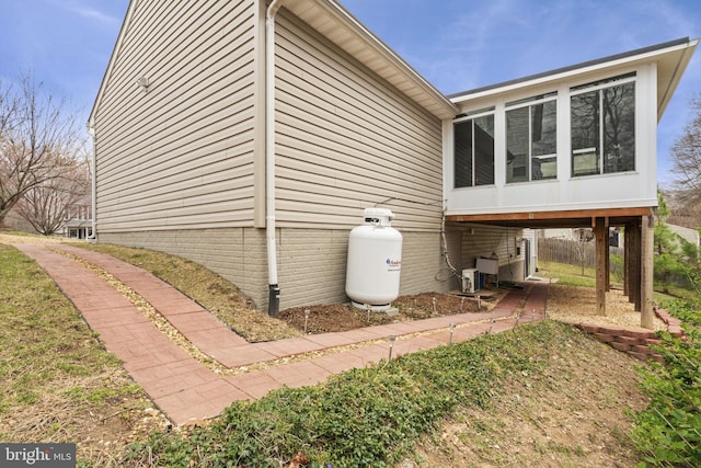 view of side of home featuring a sunroom