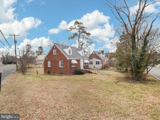 view of property exterior with a lawn and brick siding