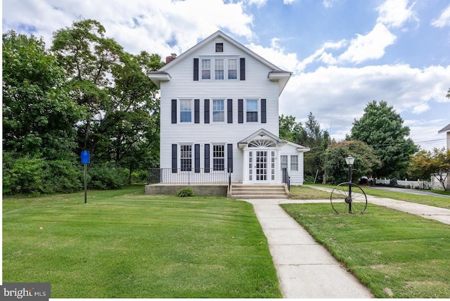 view of front of house with a front lawn and a chimney