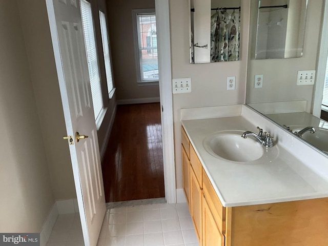 bathroom featuring tile patterned flooring, vanity, and baseboards