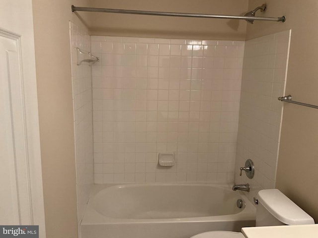 bathroom featuring washtub / shower combination, vanity, and toilet