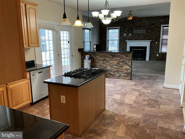 kitchen featuring dark countertops, dishwasher, and light brown cabinetry