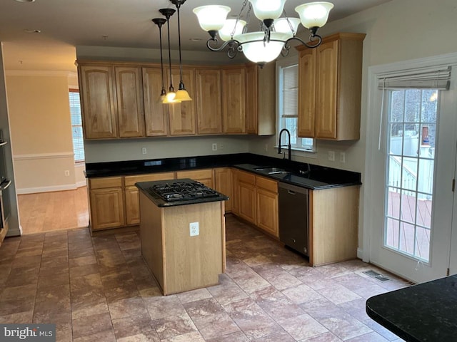 kitchen with a sink, a center island, dishwasher, dark countertops, and an inviting chandelier