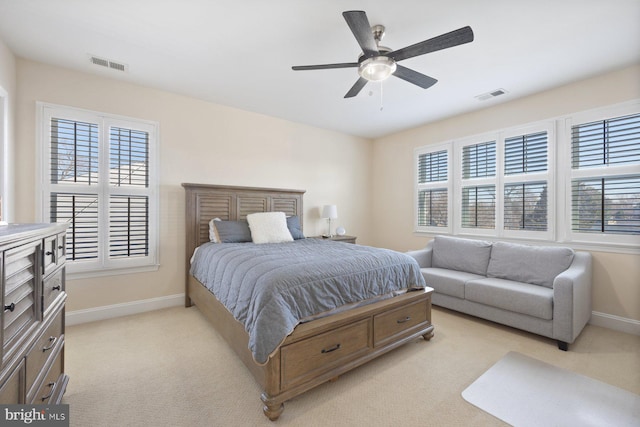 bedroom with visible vents, light carpet, baseboards, and a ceiling fan