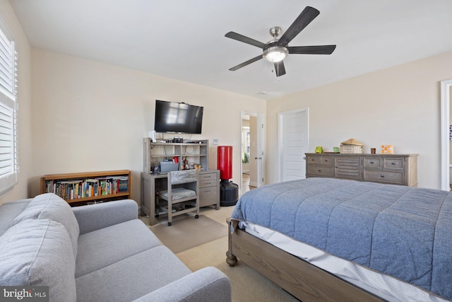 carpeted bedroom with multiple windows and a ceiling fan