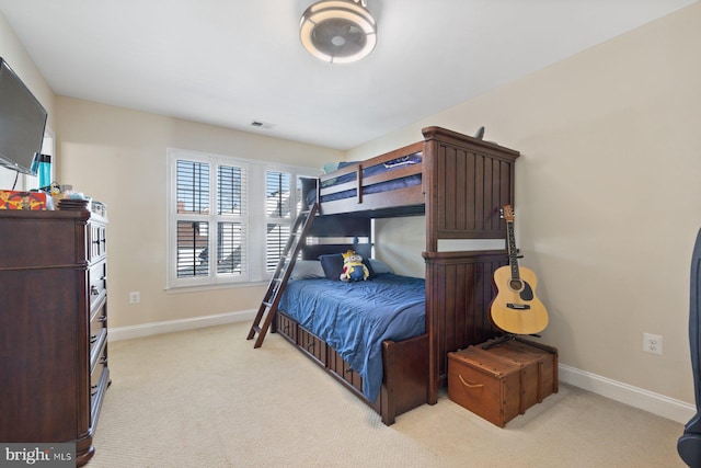 bedroom featuring visible vents, baseboards, and light colored carpet