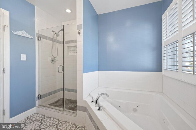 bathroom with tile patterned flooring, a shower stall, baseboards, and a whirlpool tub