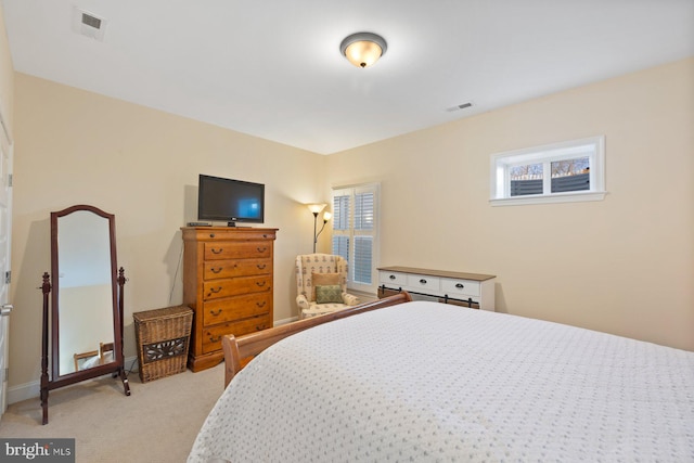 bedroom featuring light colored carpet, visible vents, and baseboards