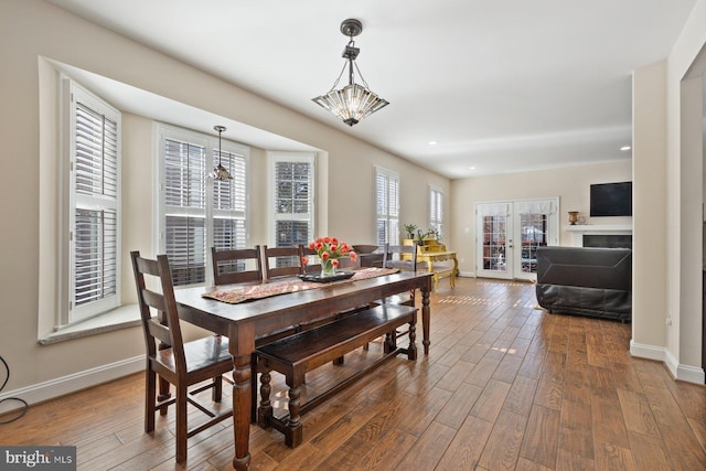 dining space featuring a wealth of natural light, french doors, and hardwood / wood-style floors