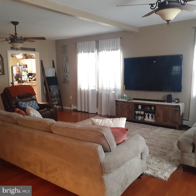 living area featuring beam ceiling, a baseboard radiator, wood finished floors, and a ceiling fan