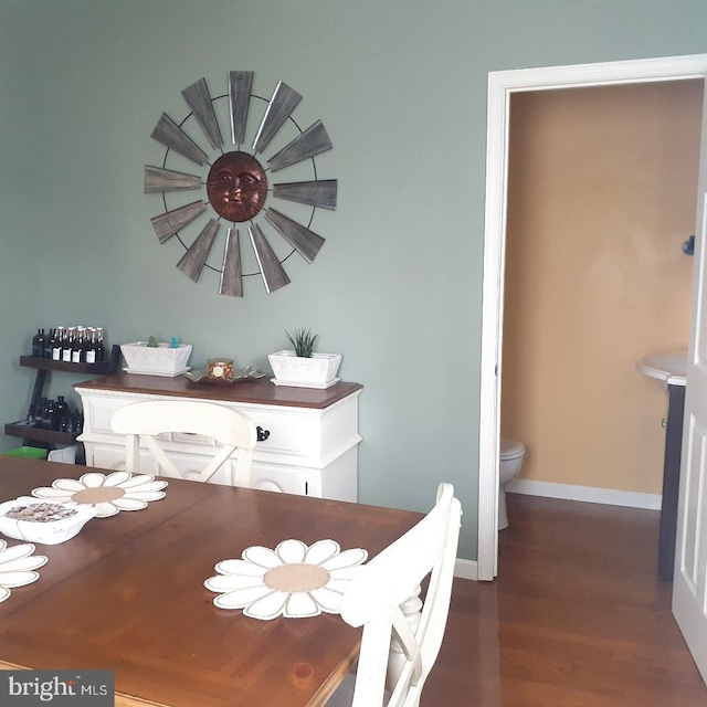 dining room with baseboards and wood finished floors