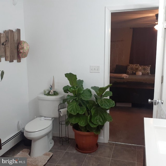 bathroom featuring a baseboard radiator, tile patterned flooring, and toilet