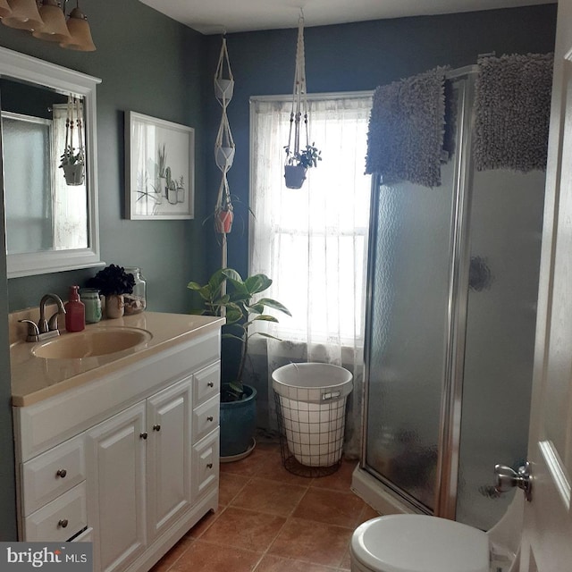 full bathroom featuring a shower stall, vanity, and tile patterned floors