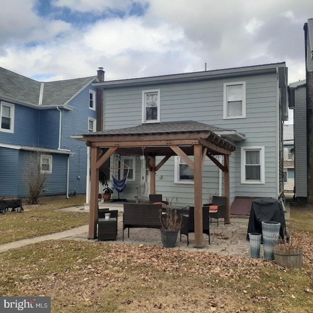 rear view of house featuring outdoor lounge area and a patio area