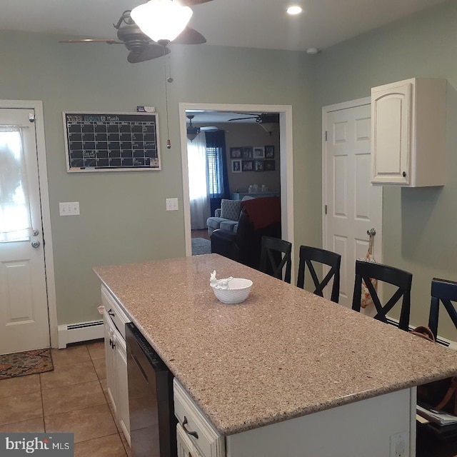 kitchen with dishwasher, a baseboard radiator, white cabinetry, and a ceiling fan