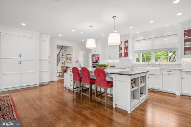 809 Cornell St, Fredericksburg, VA 22401 - kitchen featuring crown molding, white cabinets, open shelves, backsplash, and a kitchen island