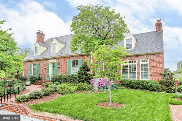 809 Cornell St, Fredericksburg, VA 22401 - cape cod house featuring brick siding, a front yard, a high end roof, and a chimney