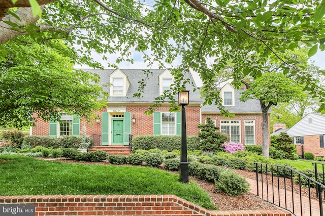 809 Cornell St, Fredericksburg, VA 22401 - new england style home with brick siding, a shingled roof, and a front yard
