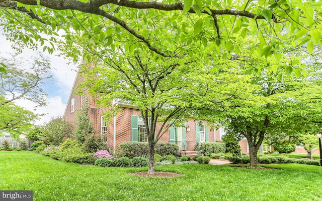 809 Cornell St, Fredericksburg, VA 22401 - view of front of house featuring brick siding, fence, and a front yard