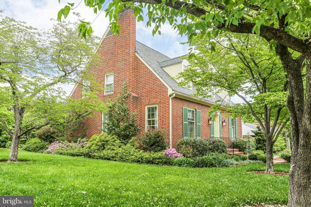 809 Cornell St, Fredericksburg, VA 22401 - view of side of property with a yard, brick siding, and a chimney